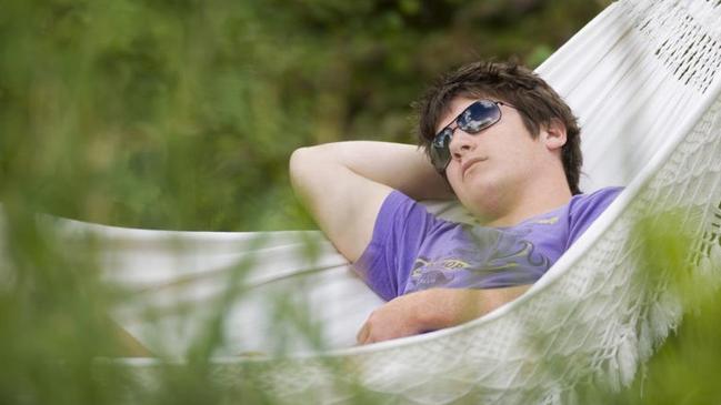Teenage boy asleep in a hammock