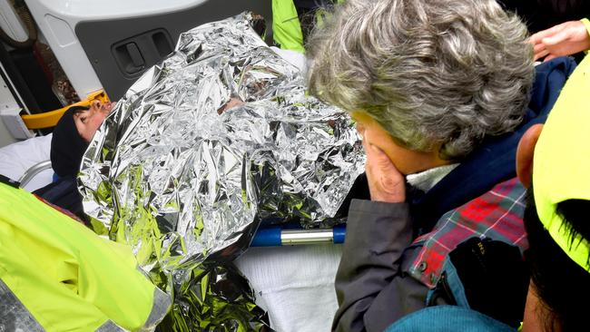 Luke is placed into the ambulance as mum looks on. Picture: Mike Keating