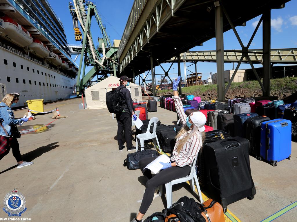 Crew members of the Ruby Princess cruise ship leaving the vessel which has been docked at Port Kembla for more than two weeks following a catastrophic COVID-19 outbreak.