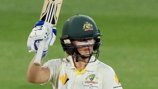 Australia’s Ellyse Perry celebrates bringing up her half century against England on Friday night.