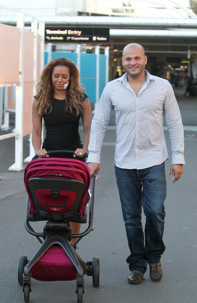 Mel B pictured with a bandage on her face at Sydney Airport after arriving from Prague with her now-estranged husband, Stephen Belafonte, in August 2012. Picture: Splash