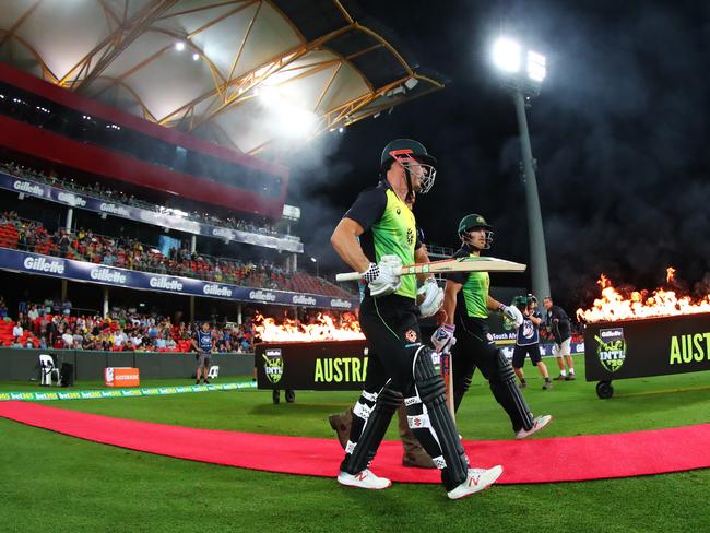 Australia's Chris Lynn and Aaron Finch walk out to bat during Saturday night’s T20 international against South Africa at Metricon Stadium. Picture: AAP Image/Jason O'Brien