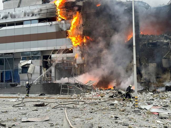 Firefighters working in a burning building at a site following an attack in Dnipro. Picture: AFP