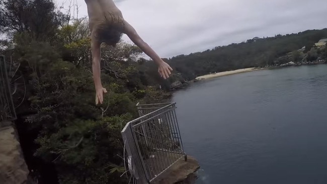 A kid jumps of Jump Rock, Collins Beach, Manly. Picture: YouTube