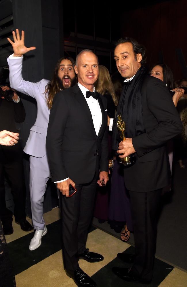 Actor Jared Leto photobombs actor Michael Keaton and composer Alexandre Desplat at the 2015 Vanity Fair Oscar Party. Picture: Larry Busacca/Getty