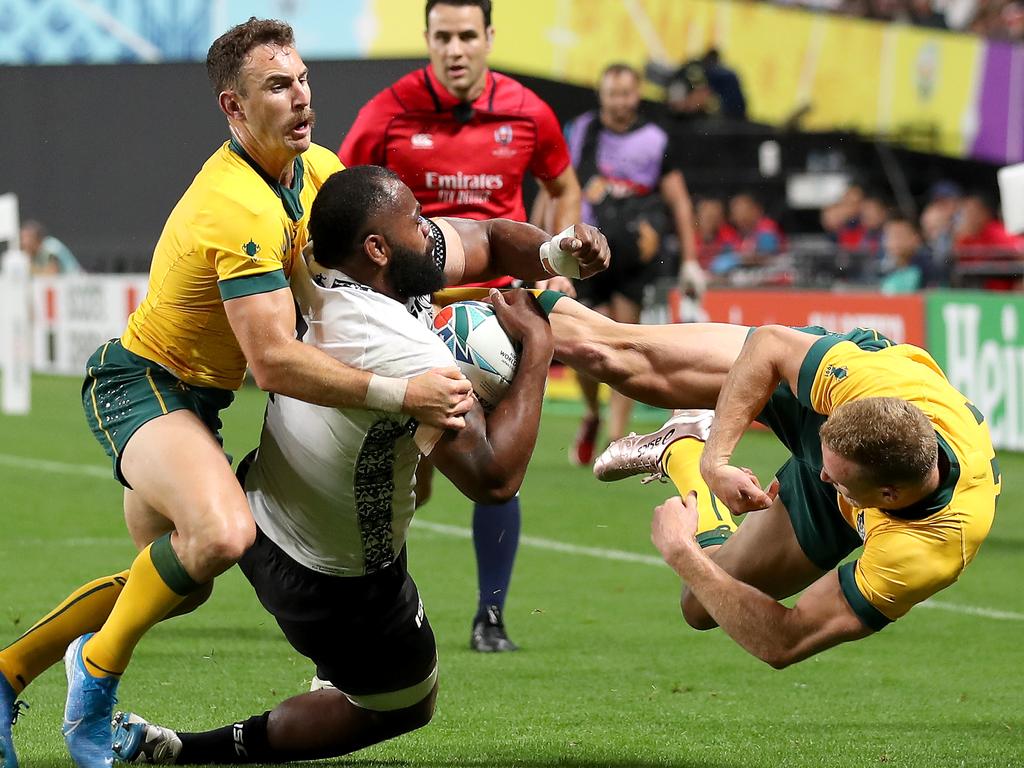 Australia’s Reece Hodge (right) flies as he is pushed away by Fiji’s Peceli Yato. Hodge has been cited over the contact. Picture: Getty Images