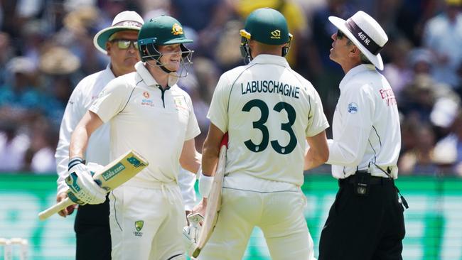 Steve Smith has animated discussion with umpire Nigel Llong after dead ball was ruled on two occasions when the Australian batsmen ran through for leg byes. Picture: AAP