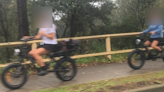 Two girls on e-bikes on the shared pedestrian path on Pittwater Rd, Manly, on Tuesday. There are increasing concerns about the speed and use of the bikes on paths, causing safety issues for pedestrians. Picture: Manly Daily