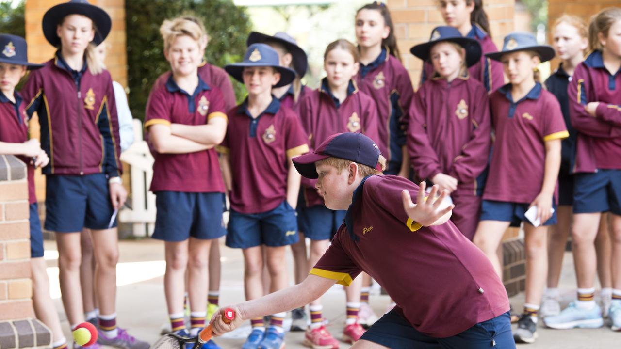 Toowoomba Anglican School student Tom Pimm returns to Casey Dellacqua during her visit to the school on Friday.