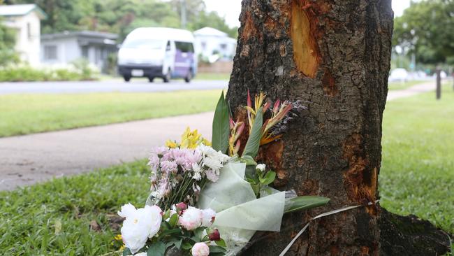 Scene of a fatal traffic crash at Manoora, where an allegedly stolen Toyota Yaris left Pease Street near the Saltwater Creek bridge and crash into a tree. Floral tributes at the scene of the crash lay among broken car pieces and tree bark. Picture: Brendan Radke