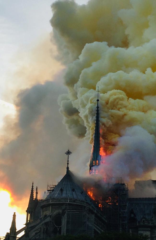 Flames and smoke are seen billowing from the roof at Notre-Dame Cathedral in Paris on April 15, 2019. (Photo by Fouad Maghrane / AFP)
