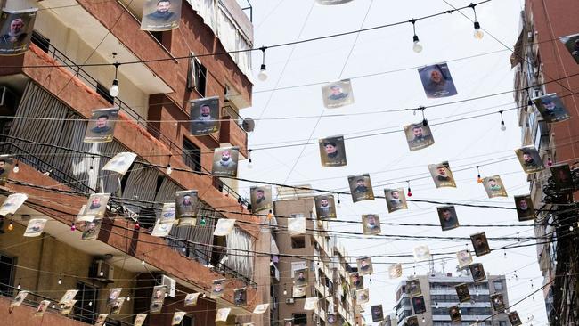 Pictures of dead Hezbollah fighters are strung over a Beirut street.