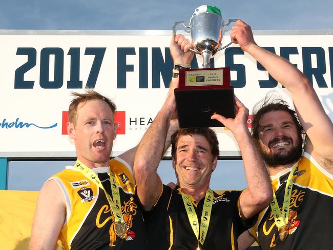 Frankston YCW coach Wayne Capp (centre) with co-captains Jie Coghlan and Kevin Lylak after winning the 2017 flag.