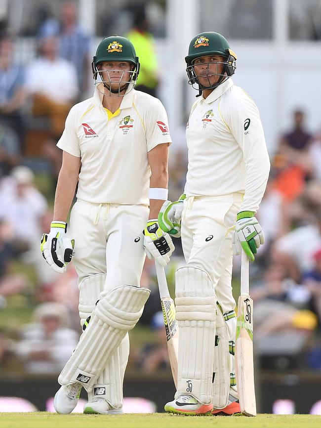 Australia's Steve Smith (left) and Usman Khawaja await the DRS ruling on Khawaja’s dismissal. Photo: AAP