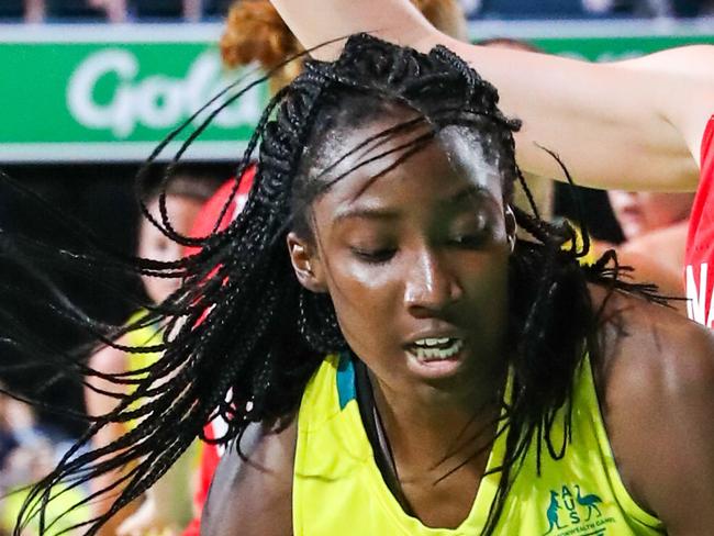 Ezi Magbegor of Australia works her way towards the hoop as cw14 defends during the Womens Preliminary Round Pool A, Australia v Canada, of the XXI Commonwealth Games at the Townsville Entertainment Centre, Townsville, Australia, Sunday, April 8, 2018. (AAP Image/Michael Chambers) NO ARCHIVING, EDITORIAL USE ONLY