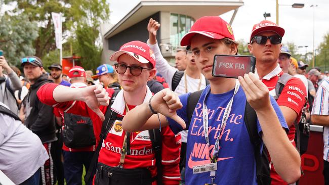 Spectators react after it was announced that the Formula 1 Australian Grand Prix 2020 was cancelled