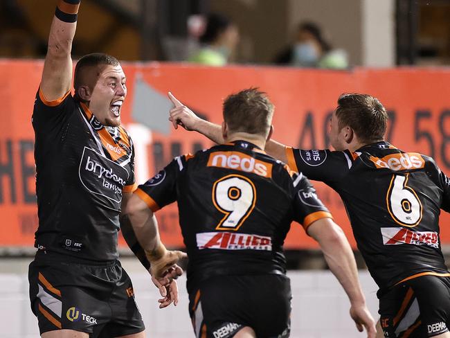 SYDNEY, AUSTRALIA - JULY 17: Sam McIntyre of the Wests Tigers celebrates scoring a try during the round 10 NRL match between the Wests Tigers and the Brisbane Broncos at Leichhardt Oval on July 17, 2020 in Sydney, Australia. (Photo by Cameron Spencer/Getty Images)