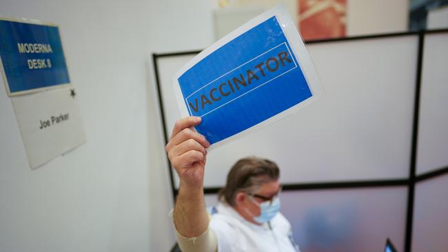 Nurse Joe Parker indicates he is ready for a vaccinator to administer the Moderna Covid-19 booster. Picture: Getty Images.