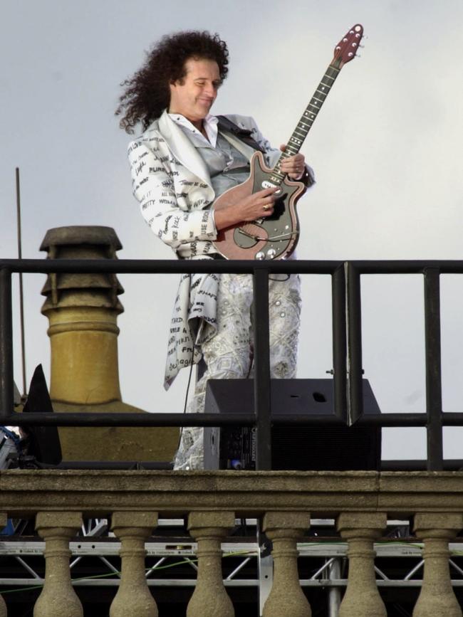 'Queen' guitarist Brian May plays the British national anthem from the roof of Buckingham Palace in 2002 for the Golden Jubilee of Britain's Queen Elizabeth II. Picture: AP.