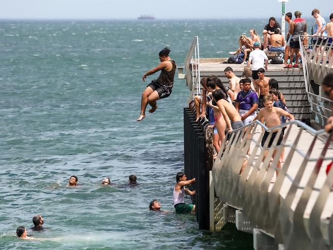 People jumping off Altona Pier as the heat hits 38 degrees on Monday. Picture: Ian Currie