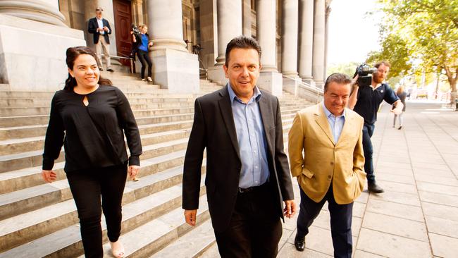 SA Best leader Nick Xenophon, centre, with candidates Connie Bonaros and Frank Pangallo outside SA Parliament.