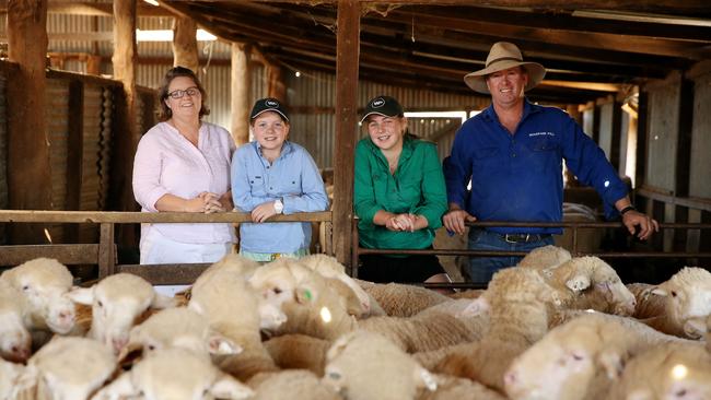 Taking a stand: Steve and Carol Huggins, and their daughters Olivia, 12, and Isobel, 15, of Woodpark Poll Merinos at Hay in the NSW Riverina. Picture: Andy Rogers