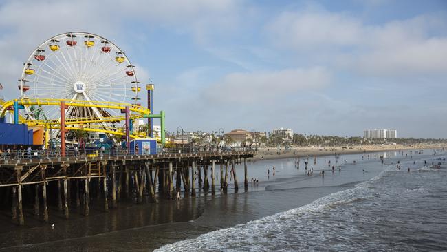 The vibrant Santa Monica pier. But down on the beach, hundreds of tents housing the homeless dominate the vista. Picture: Angus Mordant