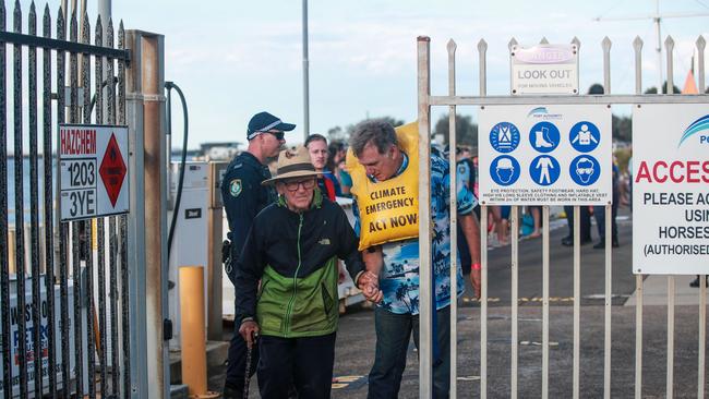 Reverend Alan Stuart, 97, walking out of the Port Authority of NSW in November last year, was among protesters arrested as they blockaded the Newcastle port coal channel over climate action. Picture: Getty Images