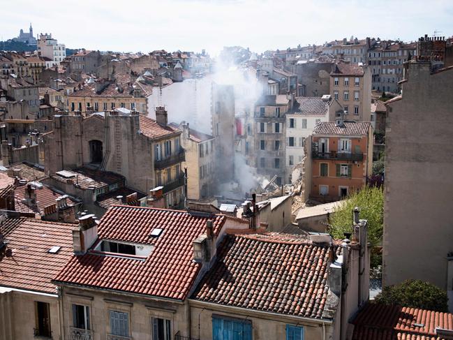 TOPSHOT - This photograph shows rubble at the 'rue Tivoli' after a building collapsed in the same street, in Marseille, southern France, on April 9, 2023. - An apartment building collapsed in an apparent explosion on April 9, 2023 in the French Mediterranean city of Marseille, injuring five people, with authorities warning up to 10 victims could be under the burning rubble. (Photo by CLEMENT MAHOUDEAU / AFP)