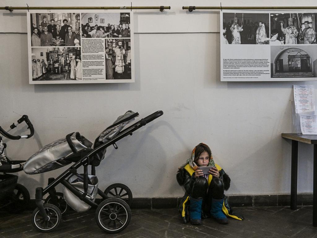 A child sits next to baby trolleys as people who fled the war in Ukraine and members of the Ukrainian diaspora pray during a mass in Krakow's Orthodox church on April 03, 2022. Picture: Omar Marques/Getty Images