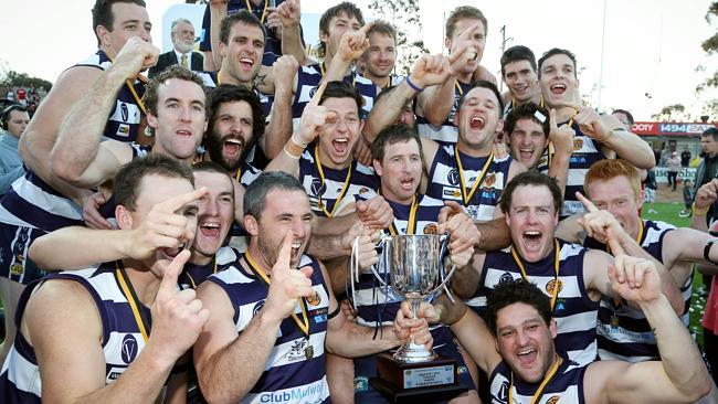 Club hero: Craig Ednie celebrates Yarrawonga’s 2012 Ovens and Murray premiership with his teammates. Photo: Simon Dallinger