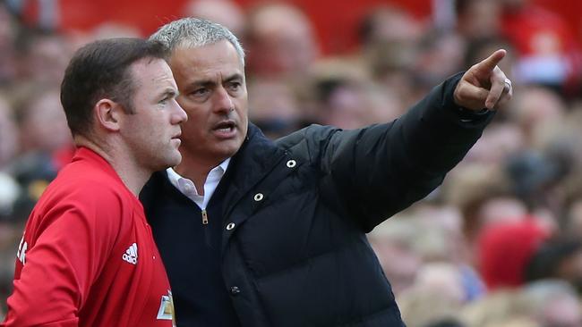 Manchester United's Portuguese manager Jose Mourinho (R) gives instructions to Wayne Rooney.