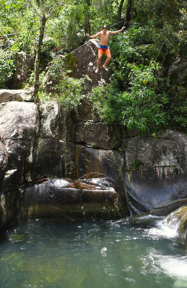 Ingham high school student Carter Bates leaps into a popular swimming hole at Little Crystal Creek in Townsville over the weekend. Picture: Cameron Bates