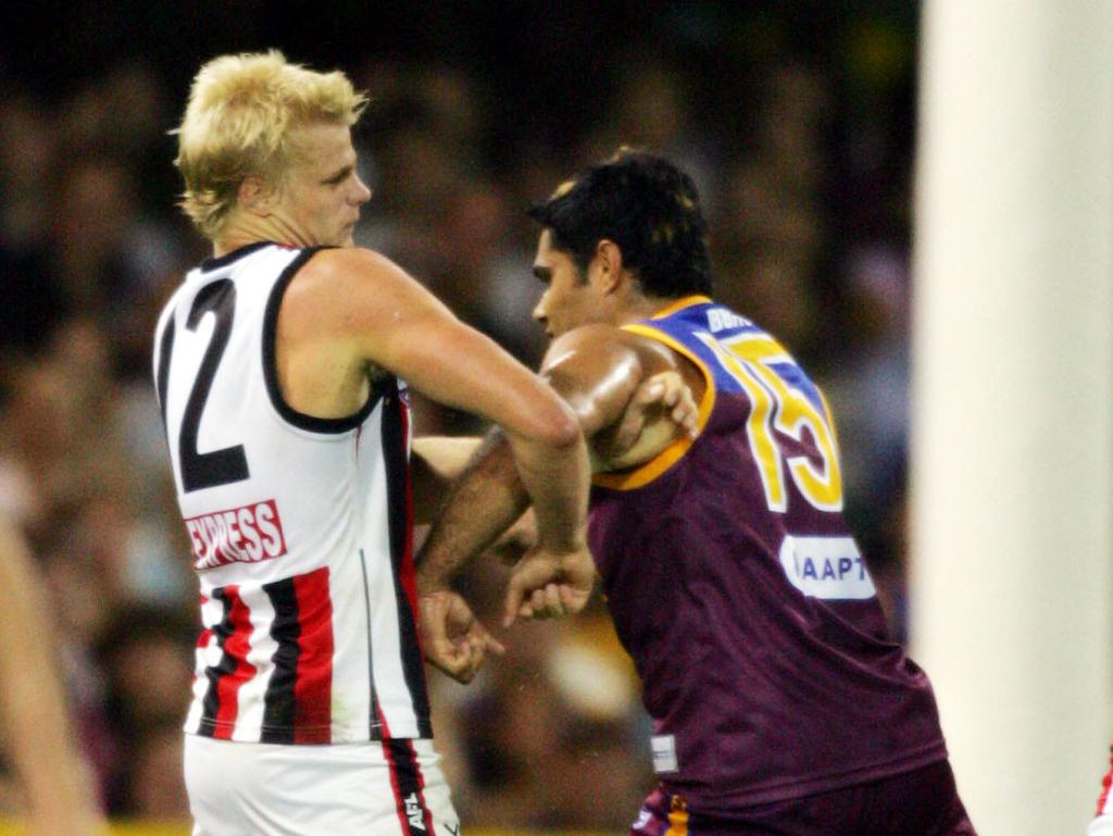 Mal Michael collides with an injured Riewoldt.