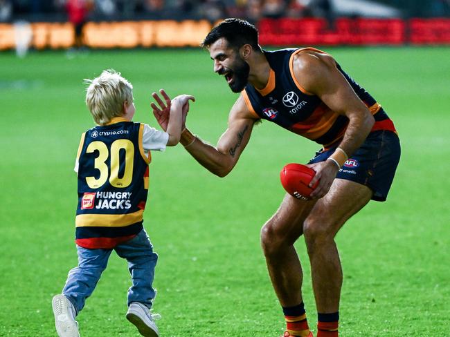 Wayne Milera celebrates a Crows win with his son.
