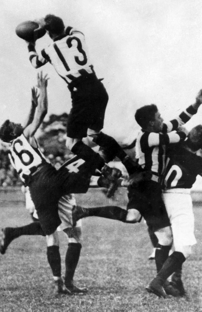 Collingwood's Dick Lee takes a sensational mark.