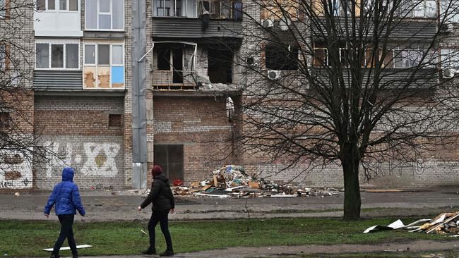 Local residents walk past a damaged building following Russian attacks in Ukraine. Picture: AFP.