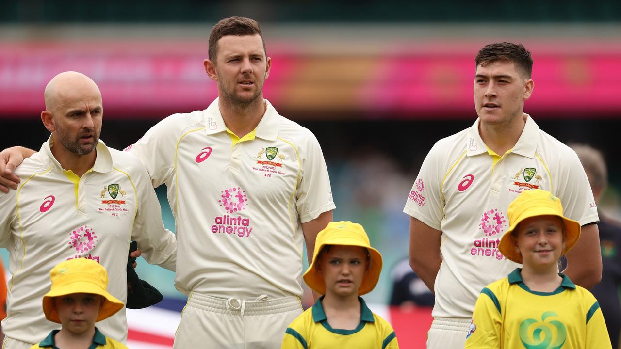 Nathan Lyon and Josh Hazlewood link arms... but Matt Renshaw stands separately during the anthem. Picture: Getty