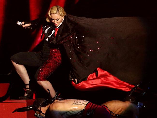 Total pro ... Madonna got back up and continued singing after being yanked off stage at the Brit Awards. Picture: AP Photo/PA, Yui Mok