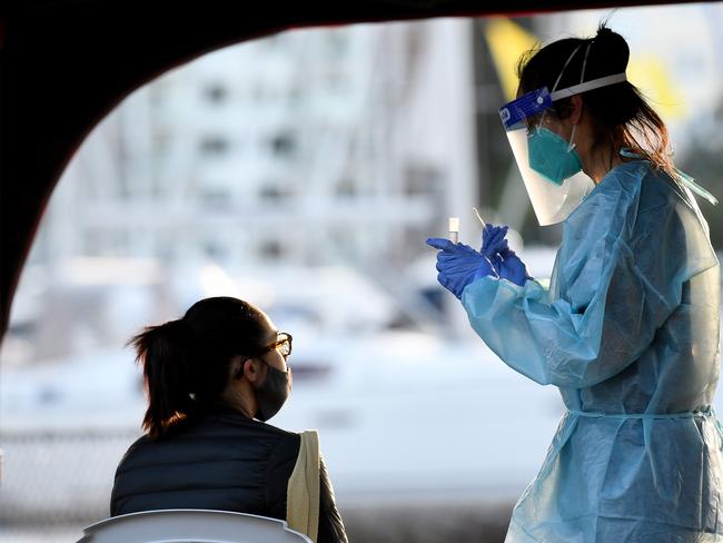 SYDNEY, AUSTRALIA - NCA NewsWire Photos JULY, 29, 2020: NSW Health workers dressed in Protection Equipment (PPE) are seen administering COVID-19 (Coronavirus) test at a pop-up testing clinic at Rushcutters Bay, in Sydney. A pop-up COVID-19 testing clinic in Rushcutters Bay Park has been established following the closure of the yacht club due after two visitors testing positive.Two people who dined at Thai Rock and the Apollo in Potts Point also visited the Cruising Yacht Club of Australia three times over July 23, 24 and 26. Picture: NCA NewsWire / Bianca De Marchi