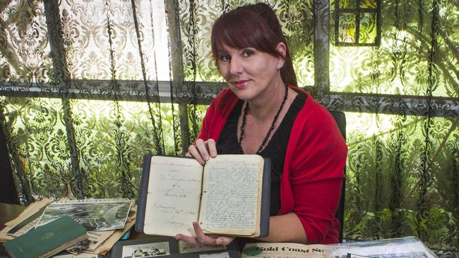 Author and journalist Rachel Syers with a long-forgotten travel diary handwritten in fountain pen last century by famous Gold Coast Mayor Sir Bruce Small. Picture: Luke Sorensen.