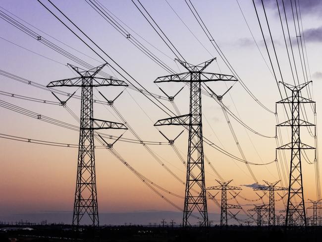 Electricity pylons during dusk evening sky sunset.