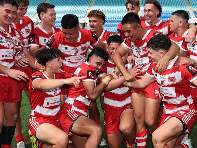 NRL National Schoolboys Cup final at CBUS Stadium  between Palm Beach Currumbin and Patrician Blacktown Brothers. The Red Army and Palm Beach Currumbin players celebrate the win.  .Picture Glenn Hampson