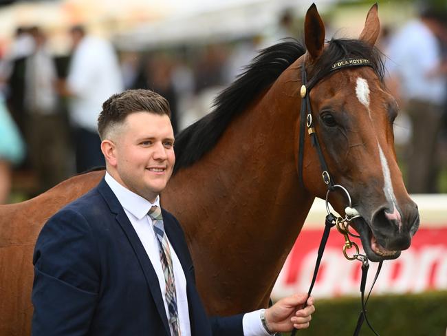 MELBOURNE, AUSTRALIA - FEBRUARY 25: Trainer Matthew Hoysted poses with Uncommon James after winning Race 9, the Ladbrokes Oakleigh Plate,  during Melbourne Racing at Sandown Lakeside on February 25, 2023 in Melbourne, Australia. (Photo by Vince Caligiuri/Getty Images)