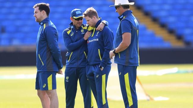 Australia coach Justin Langer, centre left, consoles Steve Smith at Headingley