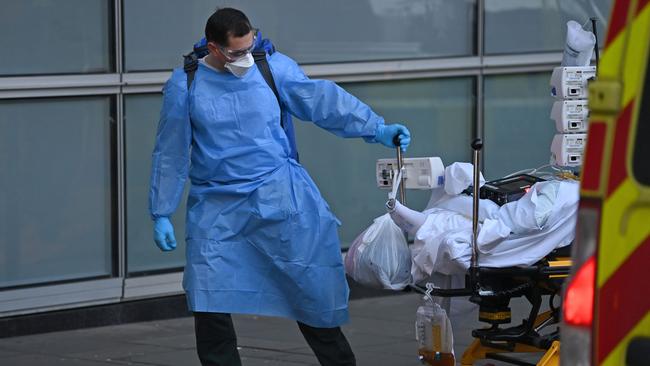 A paramedic unloads a patient from an ambulance outside the Royal London Hospital in east London earlier this year. Picture: AFP