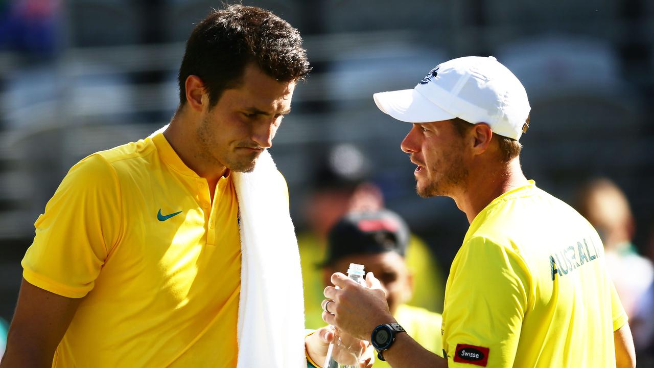 Lleyton Hewitt chats to Bernard Tomic during a Davis Cup match in 2016.