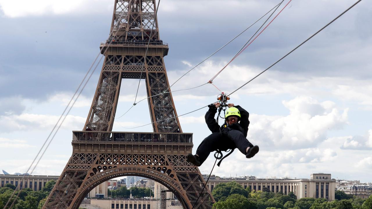 A person rides on a zip-line descending from the second floor of the Eiffel Tower. Picture: Francois Guillot / AFP