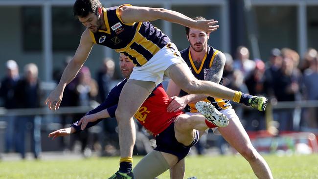 Rupertswood’s Brett Champers collects Cole Laurie of Diggers Rest during the second semi-final.