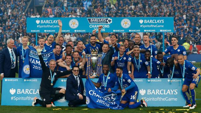 Leicester players celebrate with the Premier League trophy.